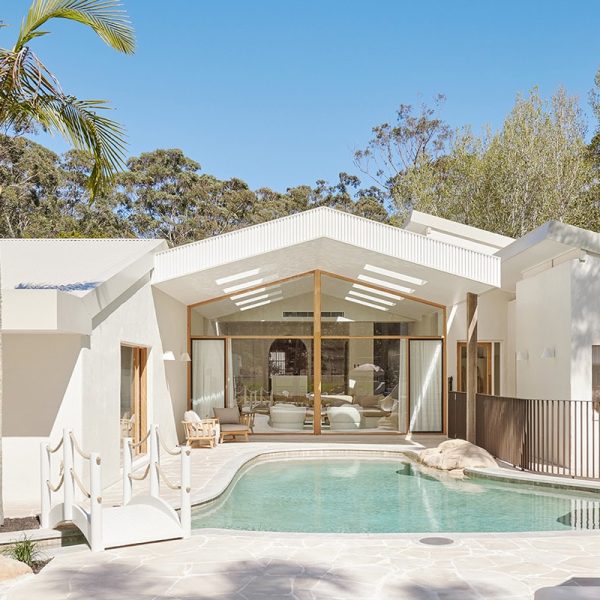 View of The Ambers property showing a large lagoon style pool and floor to ceiling windows